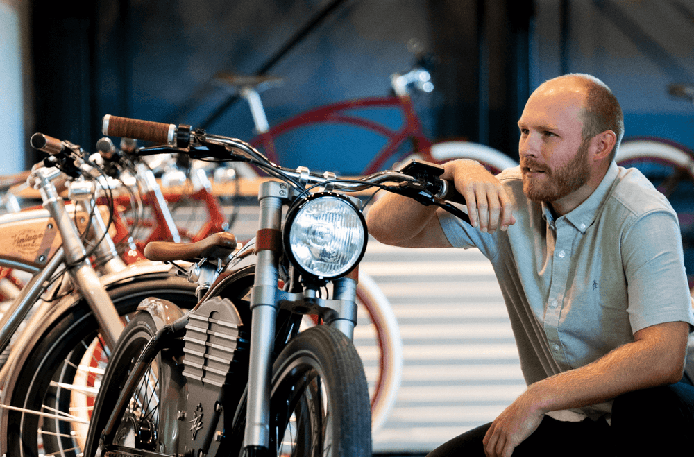 Eddie beside a Vintage bike in the Santa Clara showroom