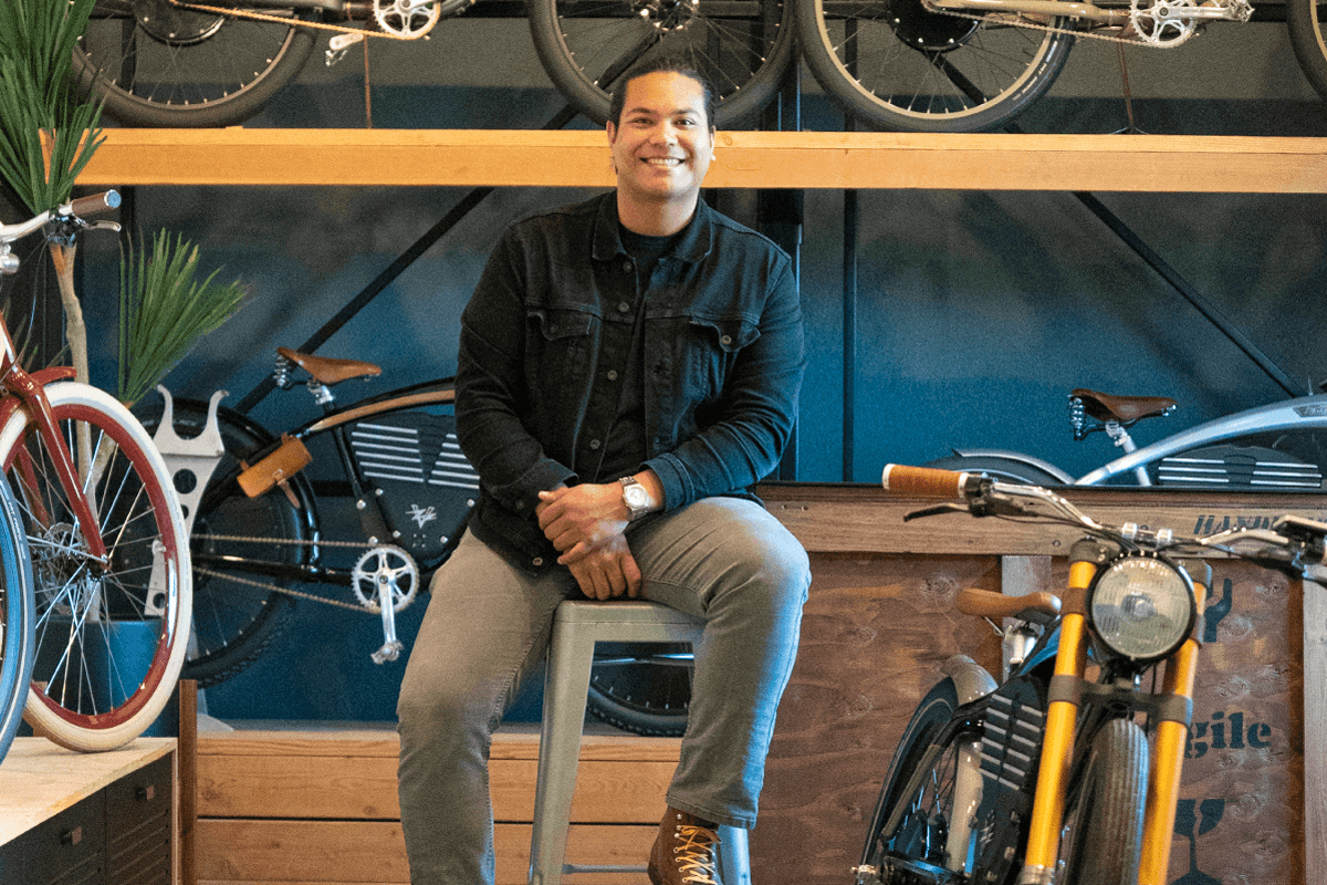 A Vintage team member seated among bikes in the showroom