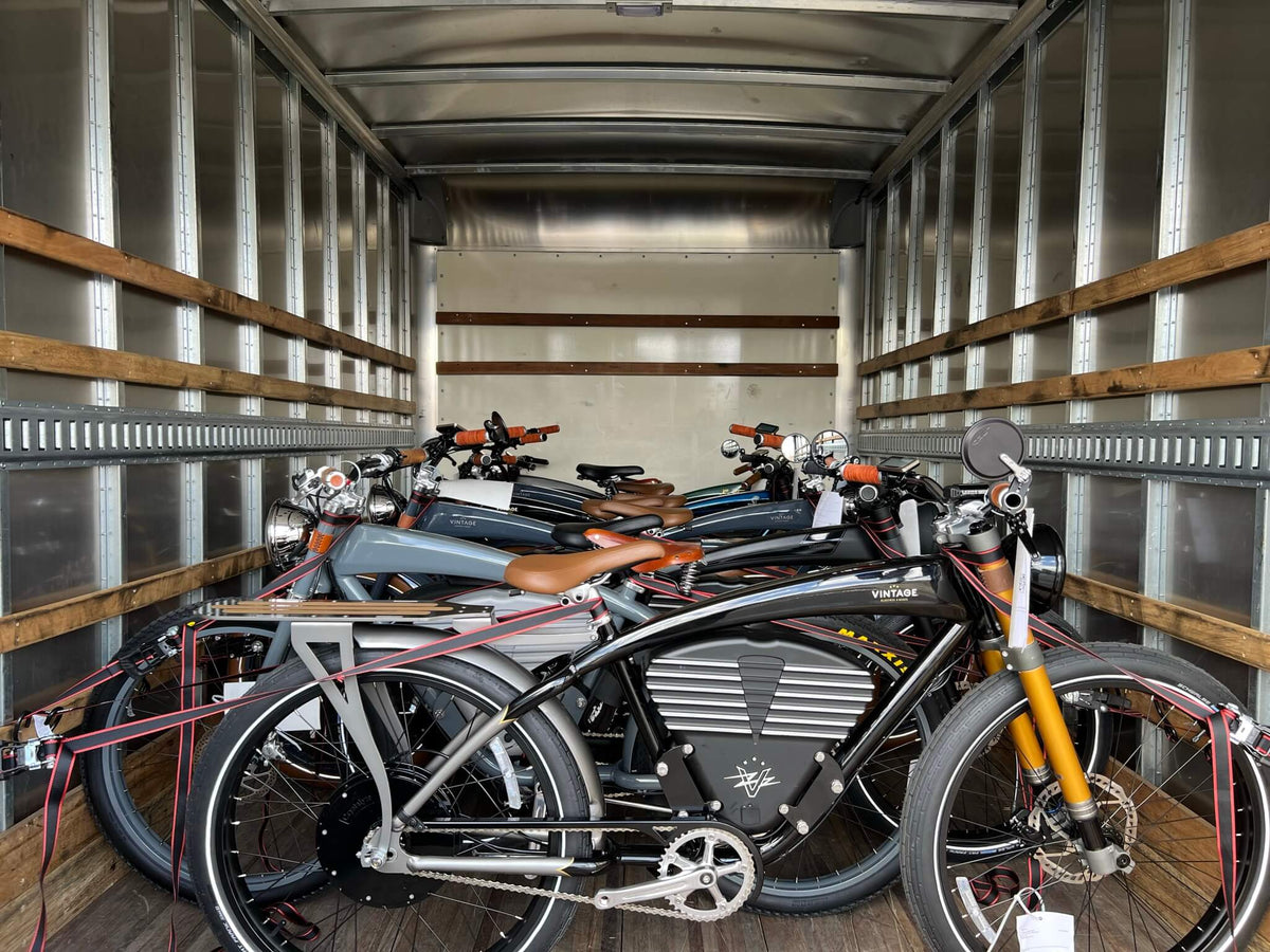 Fully assembled Vintage bikes secured upright inside a delivery truck.